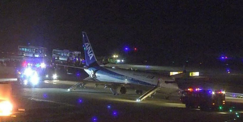 Passengers leapt down emergency slides after an ANA jet turned back to Okinawa with its right engine shut down following a loud boom mid-air - three suffered scrapes.