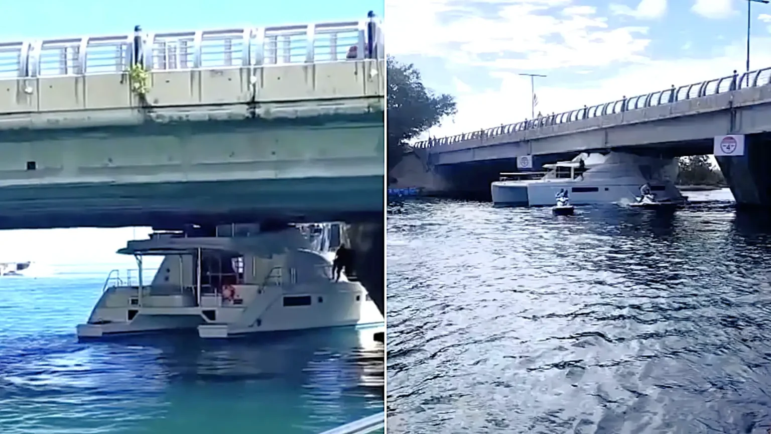 Bizarre footage shows the moment a luxury yacht became wedged under a bridge in Cancún after apparently misjudging the clearance - blocking the channel as crowds gather.