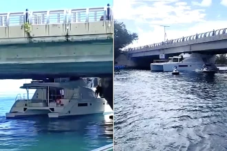 Bizarre footage shows the moment a luxury yacht became wedged under a bridge in Cancún after apparently misjudging the clearance - blocking the channel as crowds gather.