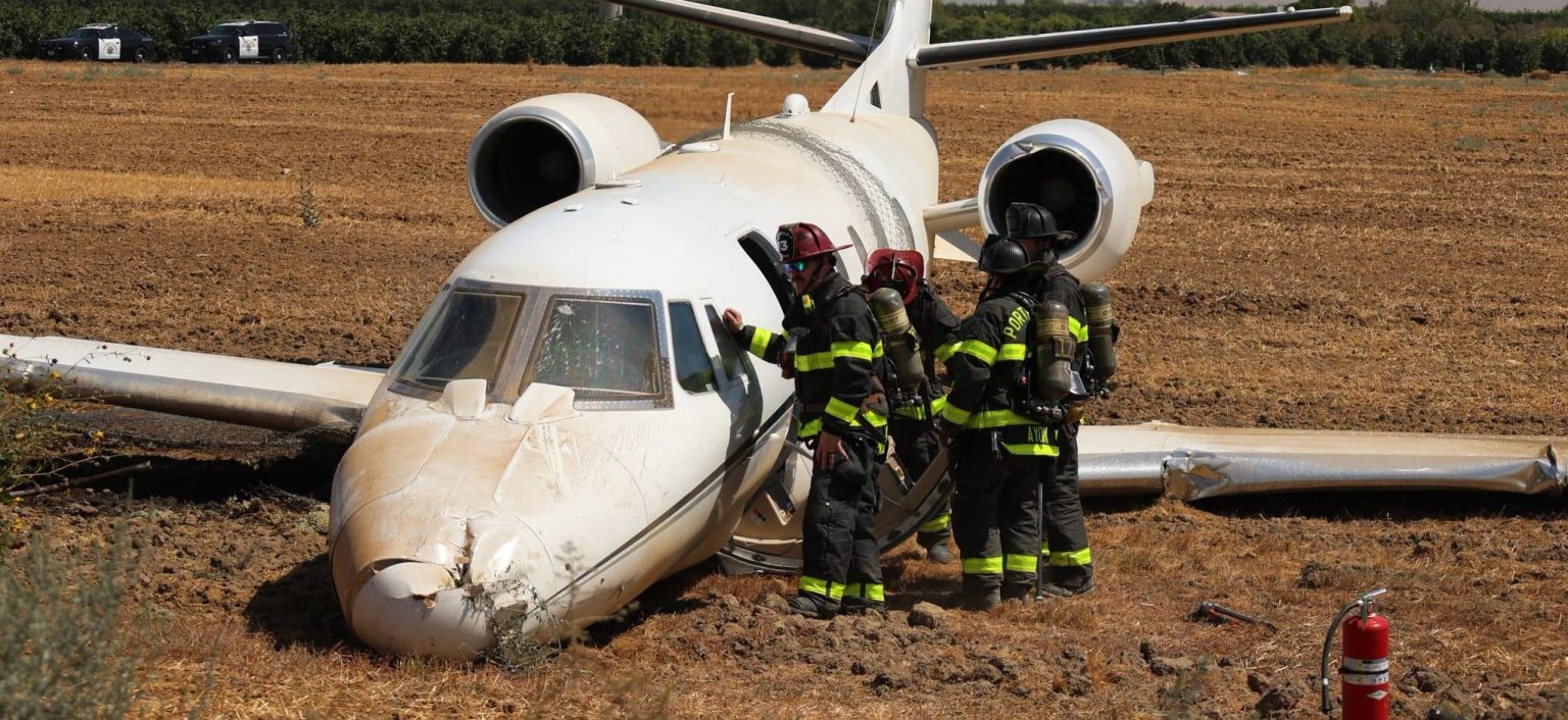 Dramatic pictures show a private jet wrecked in a field after it overshot a runway with four doctors and two pilots on board - all six escaped alive.