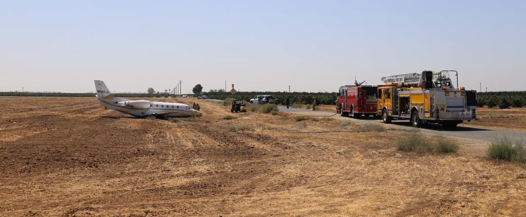 Dramatic pictures show a private jet wrecked in a field after it overshot a runway with four doctors and two pilots on board - all six escaped alive.