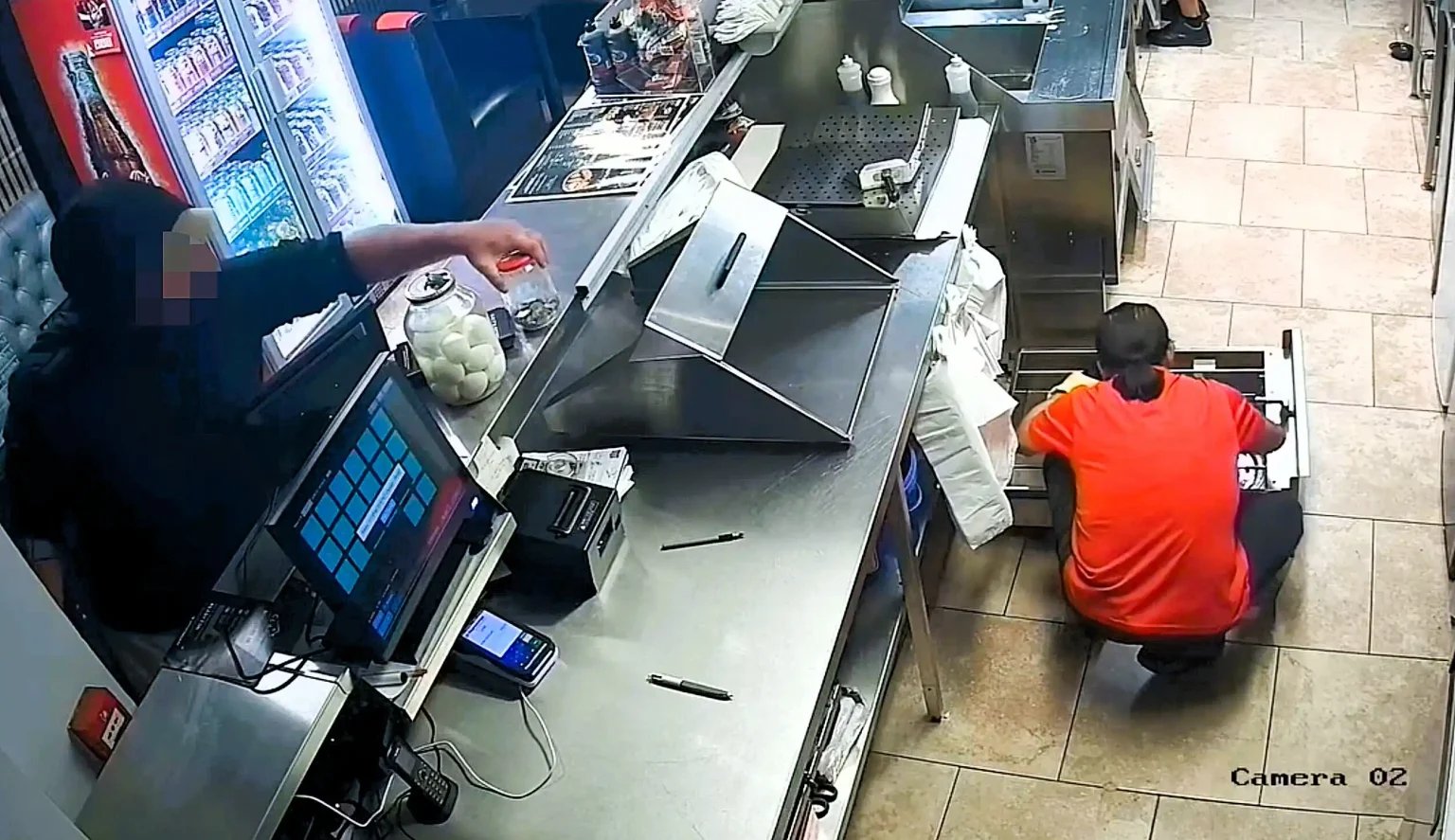 This is the brazen moment a thief swipes a fish and chip shop's tip jar while oblivious staff work just inches away - after staff had glued it to the counter.