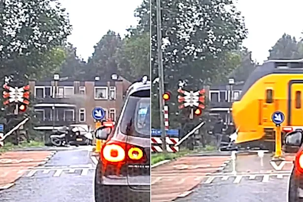 Two teens smashed their fatbike into a level crossing barrier and spilled onto the tracks - dashcam caught them dragging the bike clear as a train bore down