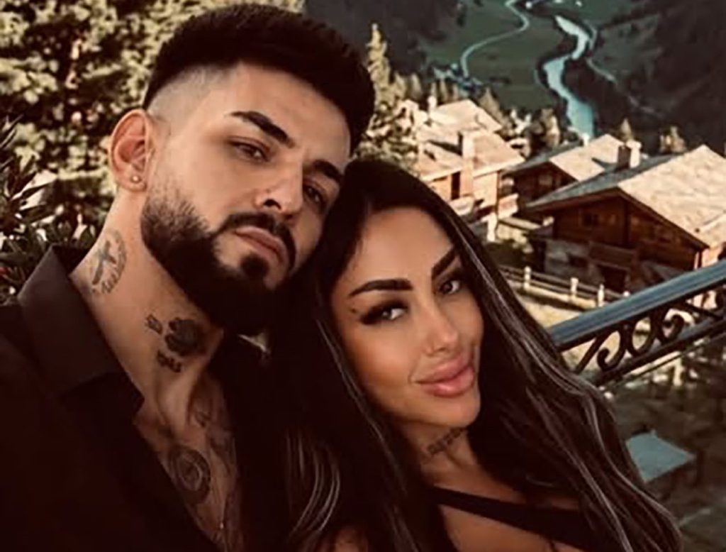 A man suspected of killing his girlfriend and dumping her body in a suitcase in a Romanian river has surrendered to police in Switzerland after allegedly fleeing 700 miles.