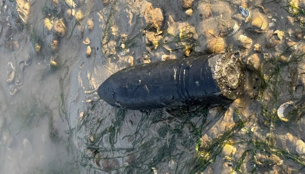 A live World War Two shell has been blown up on a British beach after a member of the public spotted the six-inch device buried in the sand.