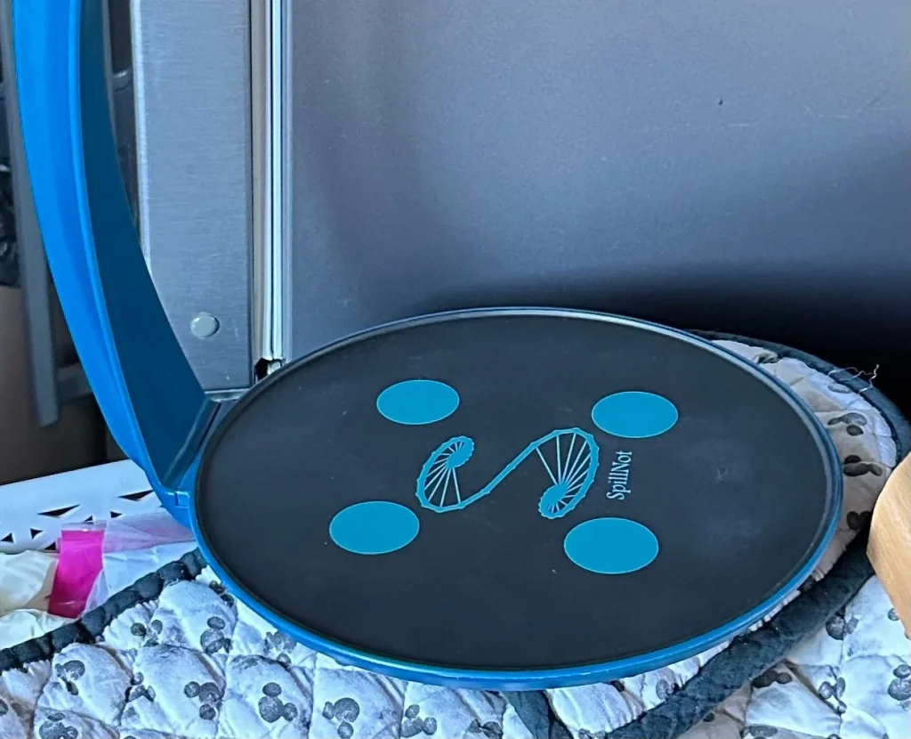 The SplinNot mobility aid, a blue curved device with a black interactive platform base.