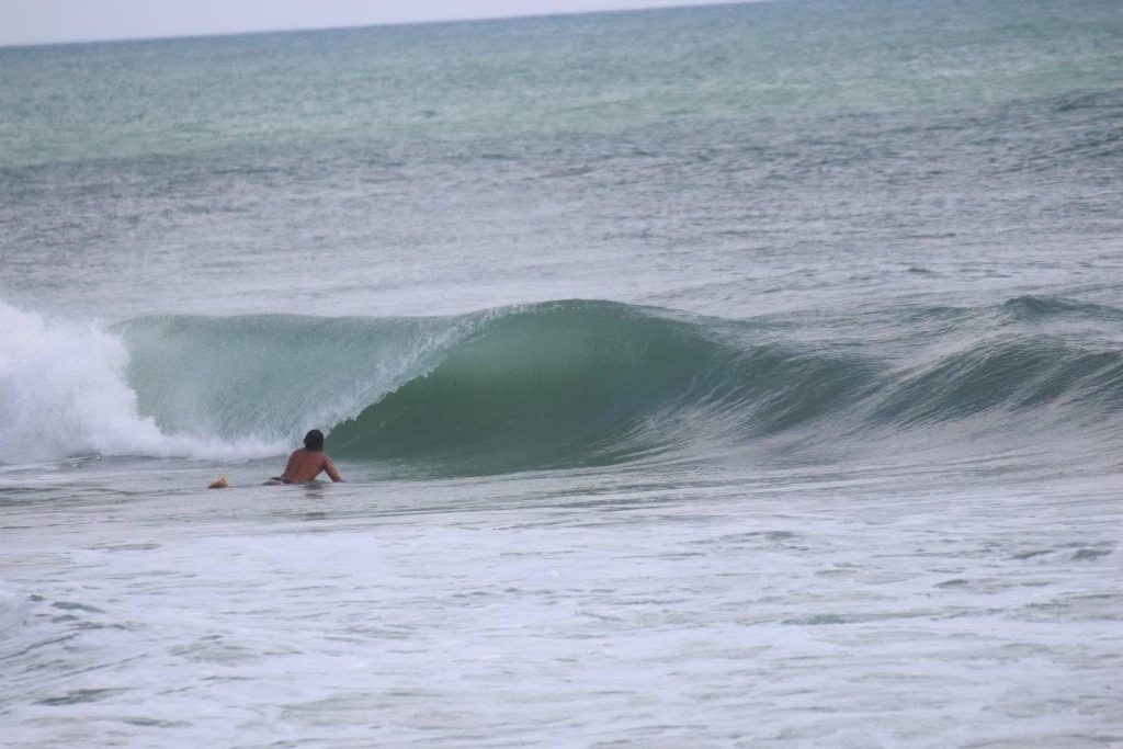 A woman was taking photos of her partner as he boogie boarded off a Florida beach when he was swept under a wave and never resurfaced - his body was found two days later.