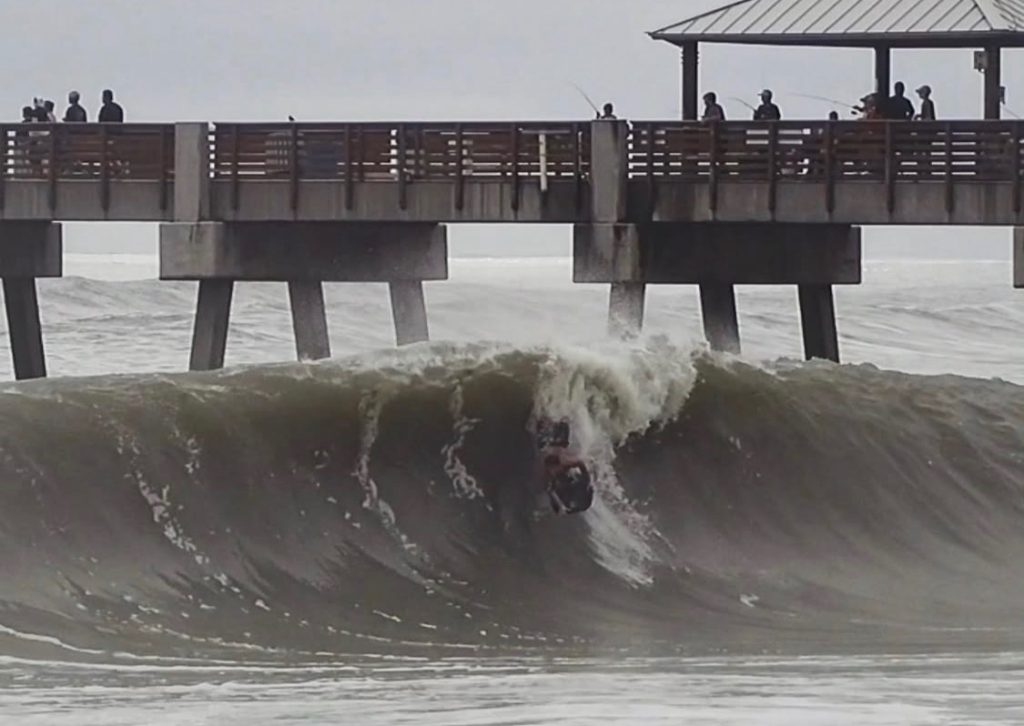 A woman was taking photos of her partner as he boogie boarded off a Florida beach when he was swept under a wave and never resurfaced - his body was found two days later.