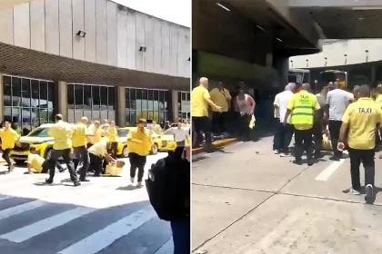 Shocking footage shows at least 20 taxi drivers turning a Rio de Janeiro airport exit into a makeshift boxing ring in a chaotic mass brawl over a passenger pick-up spot.
