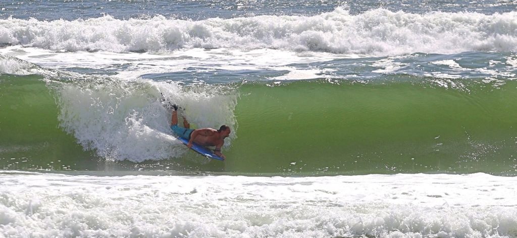A woman was taking photos of her partner as he boogie boarded off a Florida beach when he was swept under a wave and never resurfaced - his body was found two days later.