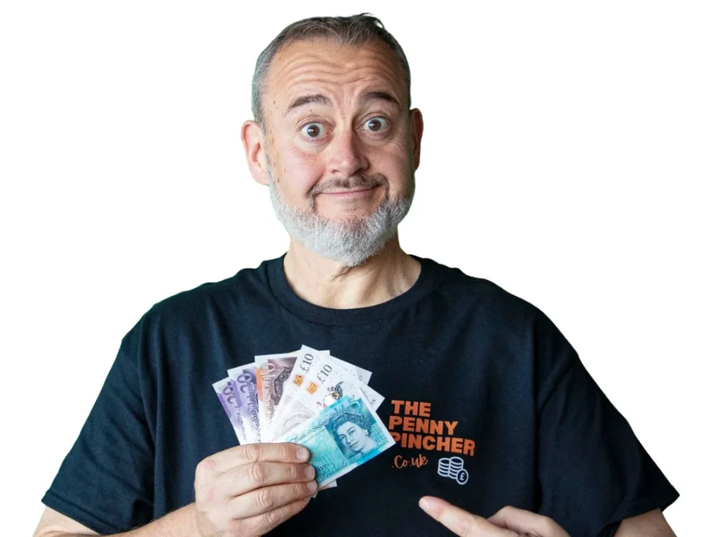 Man holding multiple banknotes in both hands, wearing black The Penny Pincher hoodie.