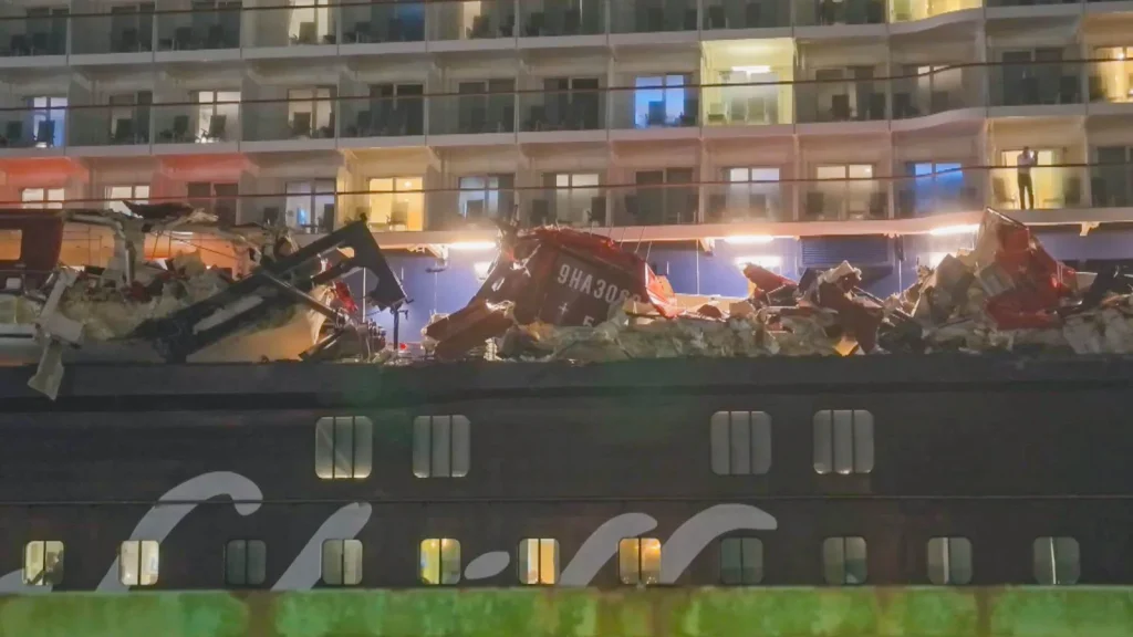 A cruise liner has crashed into container ships during a storm, tearing open a vessel’s hull and leaving passengers shaken.