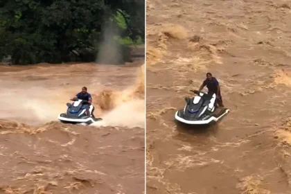 A terrifying video shows the moment a thrill-seeker was hurled into raging floodwater from his jet ski, before miraculously climbing back on.