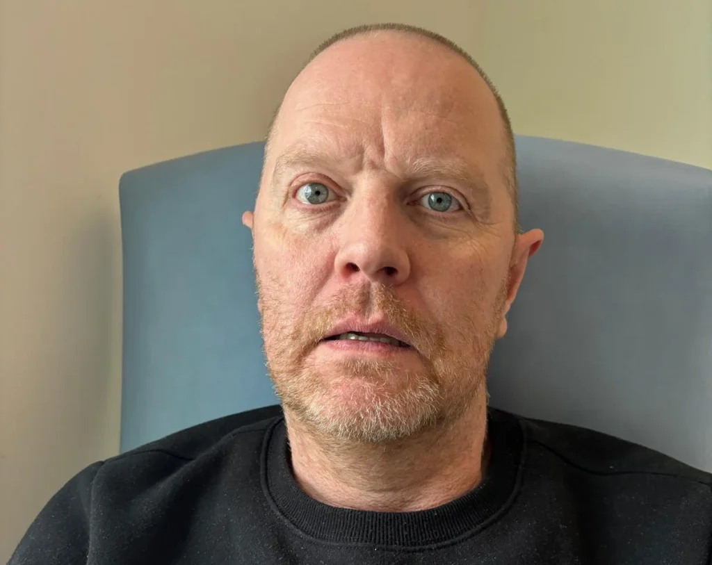 Man in casual clothes at hospital or clinic.