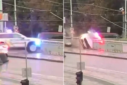 Police officers dramatically rescued after patrol car skids off Prague bridge into freezing river - a heroic runner jumped into icy water to save them.