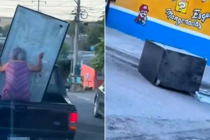 Elderly woman desperately clings to fridge sliding off moving pickup truck in Mexico - dramatic moment captured on video as appliance crashes onto road.