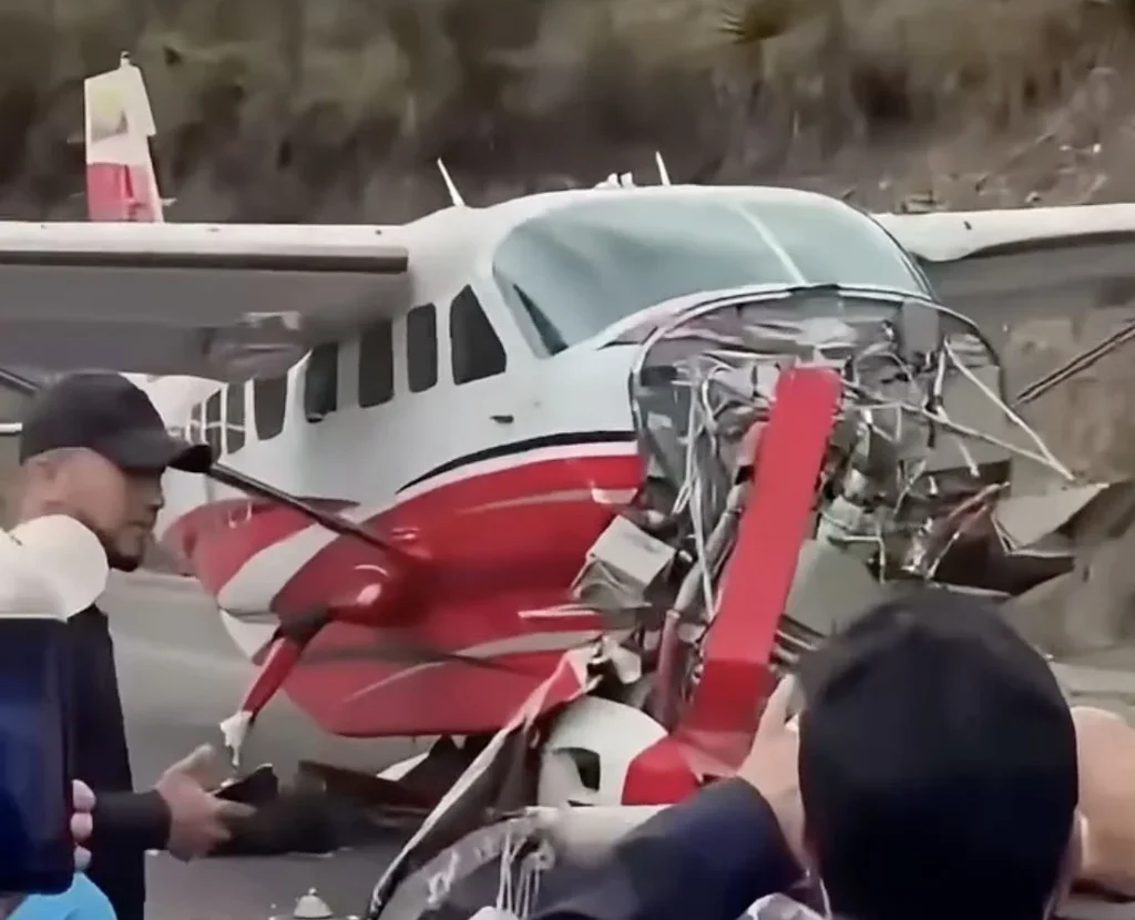 A Cessna plane carrying valuables plunged down an embankment and crashed onto a busy road in Ecuador after overshooting the runway. Both crew members are safe.