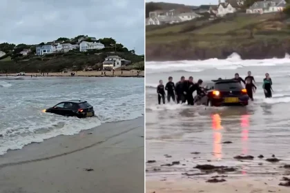 An ‘idiot’ driver was clapped off a beach after nearly losing their car when it was marooned on the sands outside a posh holiday hotspot.