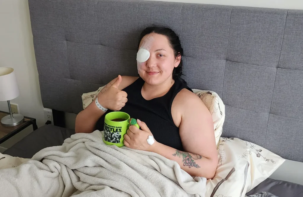 Woman lying on a hospital bed resting during recovery.