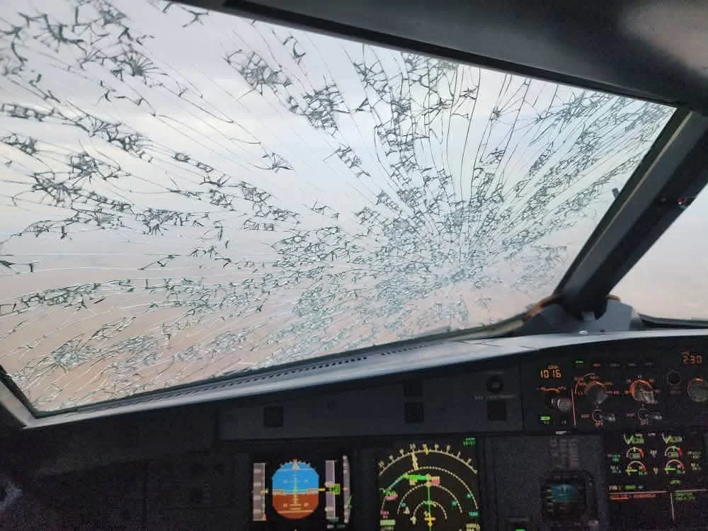 A passenger jet sustained a damaged nose and cockpit after flying into a severe hailstorm. Passengers and crew escaped unharmed after their plane was battered by the storm.
