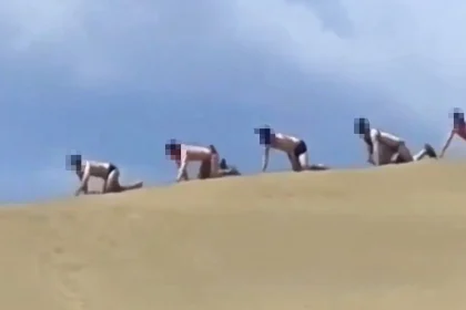 A “puppy parade” organiser faces a fine after kinksters were seen crawling across a protected sand dune. Legal proceedings have been issued against a kinky community.