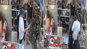 Thief caught on CCTV stealing replica rifle from antique shop by hiding it under his jacket. The weapon was not real but used by historical re-enactors near Birmingham.