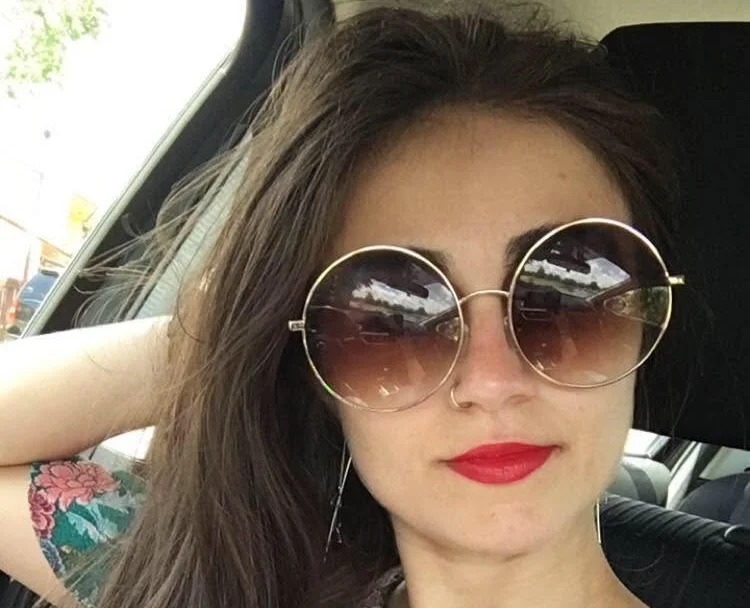 A tourist plunged hundreds of metres to her death after reportedly stepping away from a mountain path to take a photograph.